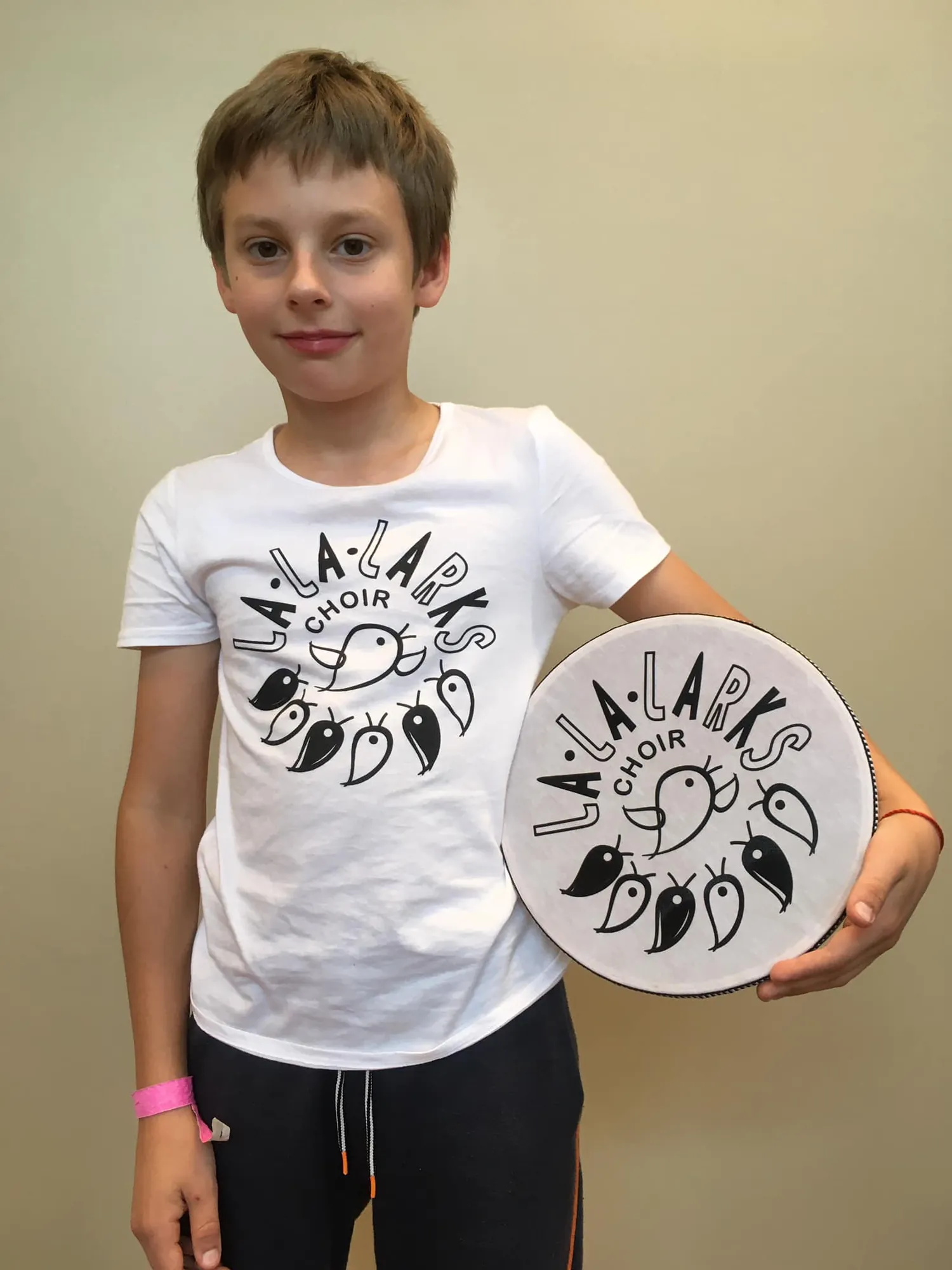 Children showing off the new La La Larks logo