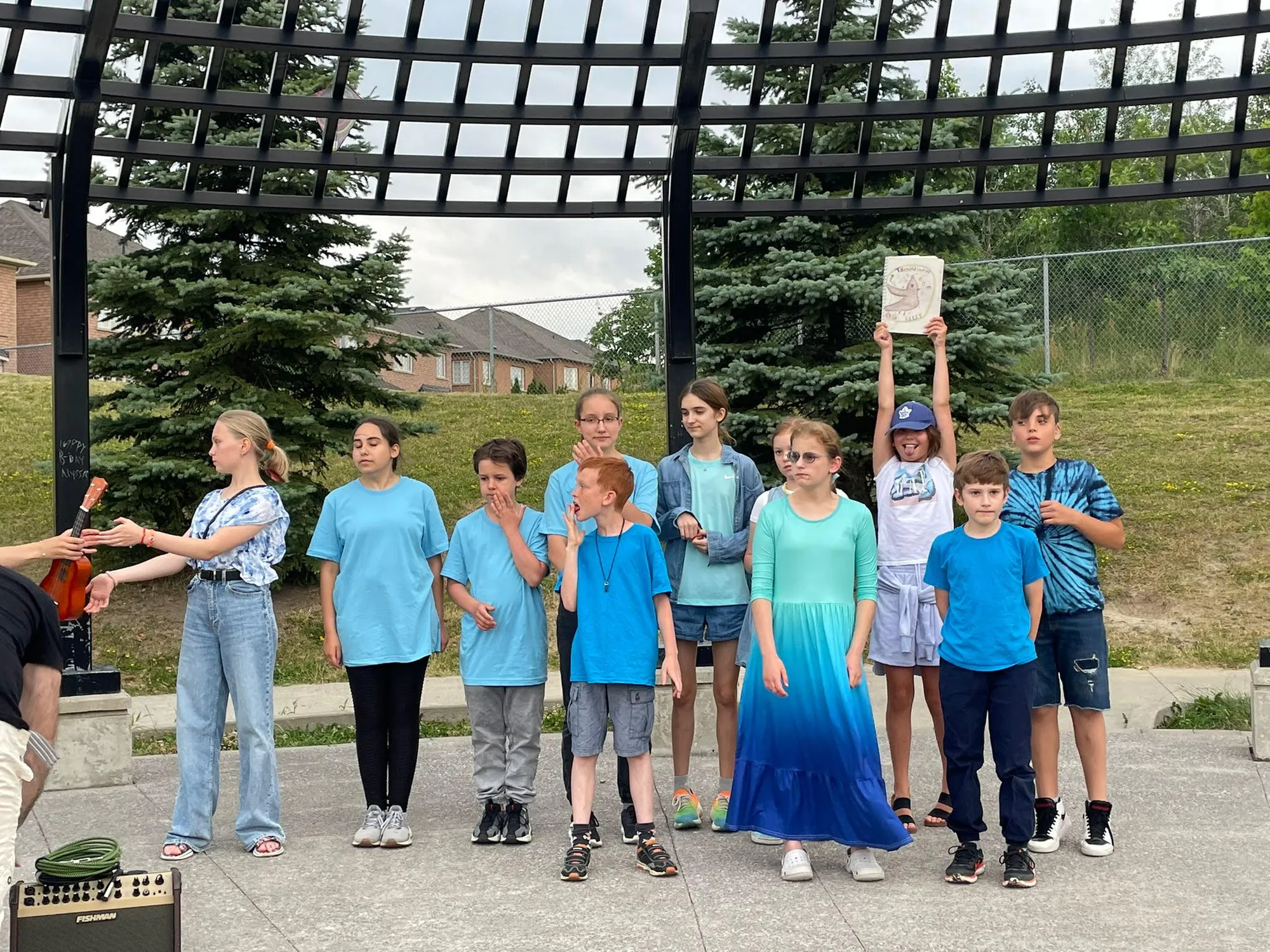Children performing on stage at the outdoor pavilion