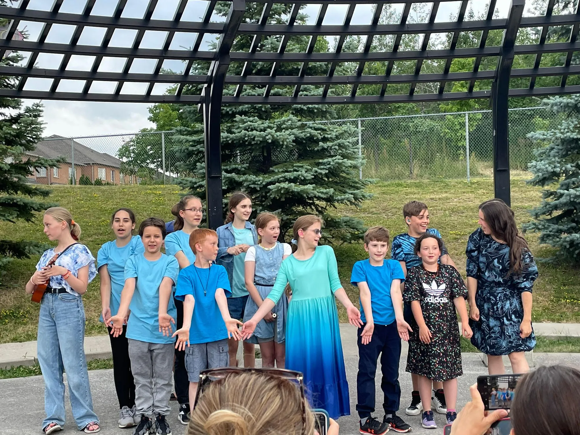 Children choir performing together in the park